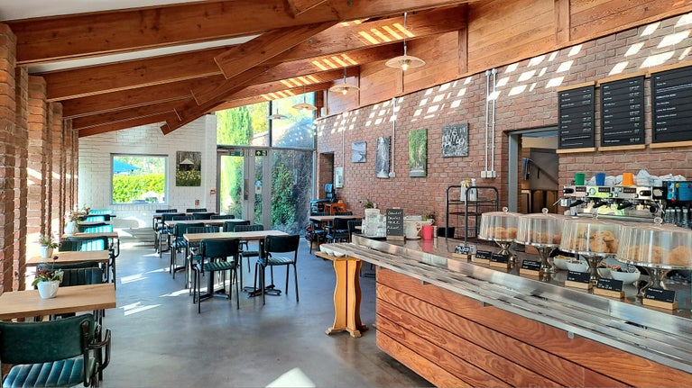 Tables, chairs and a serving counter inside the café at Trengwainton